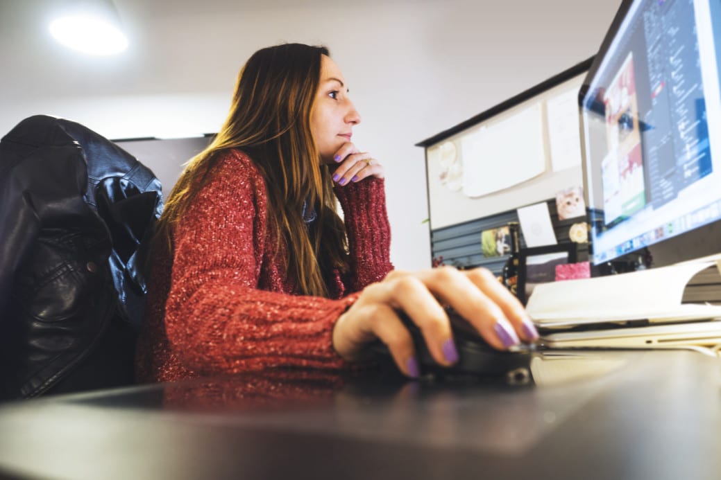 decision making with analytics and BI - girl in red sweater working at computer